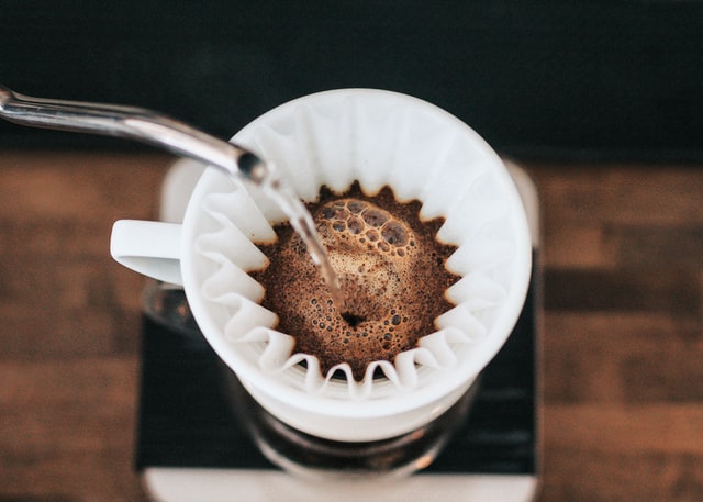 a barista pouring coffee