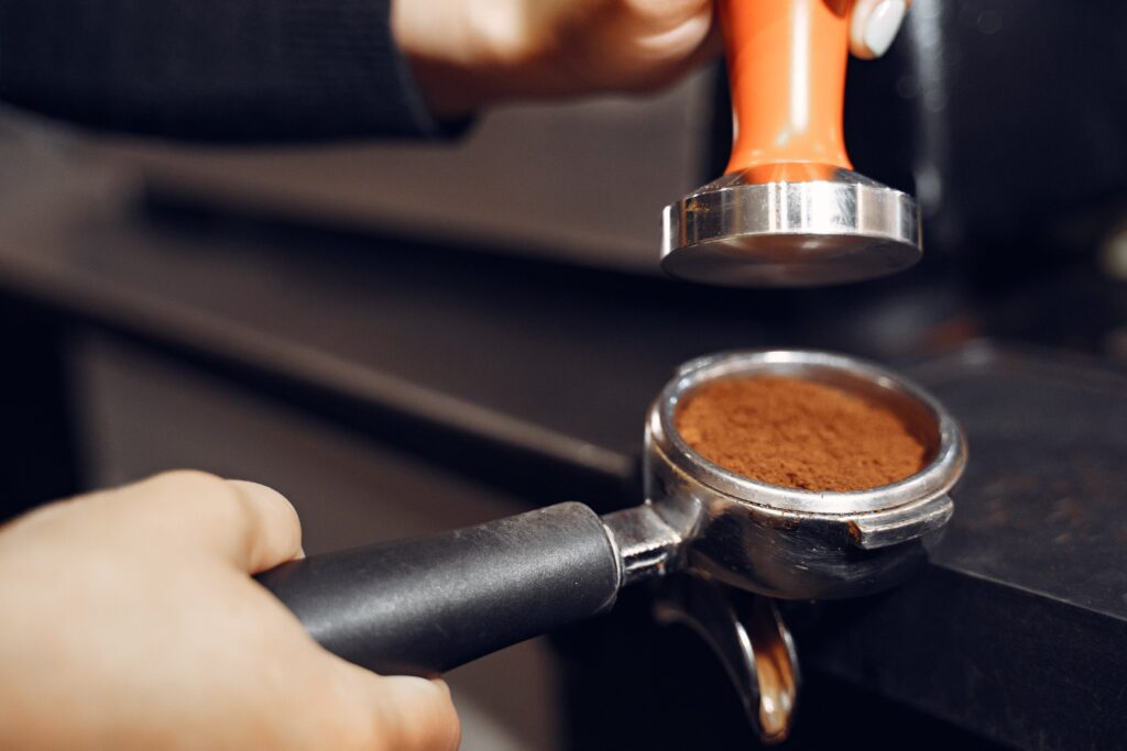 barista cafe making coffee preparation showing tamper