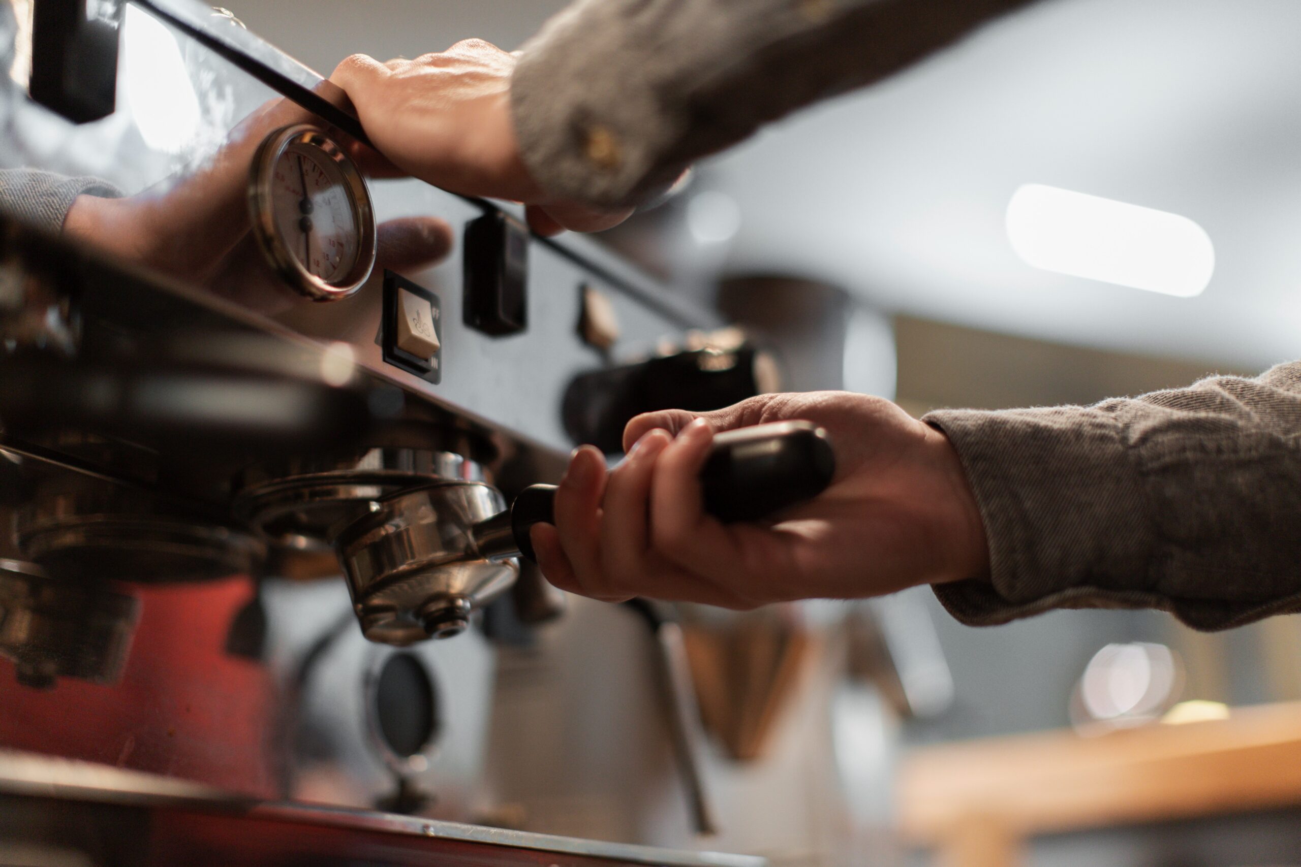 Close up hands working on espresso machine